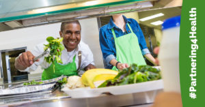 Cafeteria worker serves salad